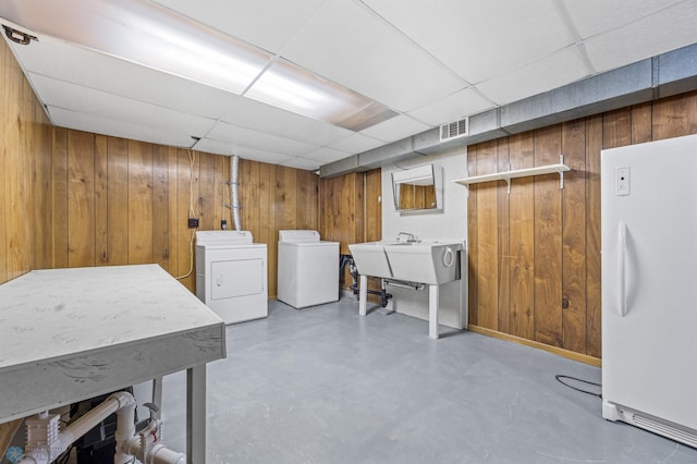2207 16th St S, Fargo, ND 58103 - laundry area with wooden walls and washing machine and dryer