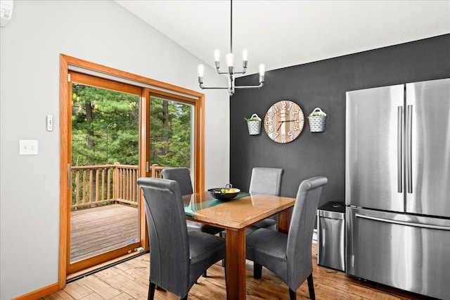 25 Maki Rd, Esko, MN 55733 - dining space featuring a chandelier, wood finished floors, and lofted ceiling