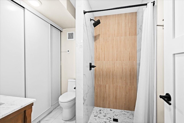 25 Maki Rd, Esko, MN 55733 - full bath featuring a stall shower, toilet, marble look tile flooring, and vanity