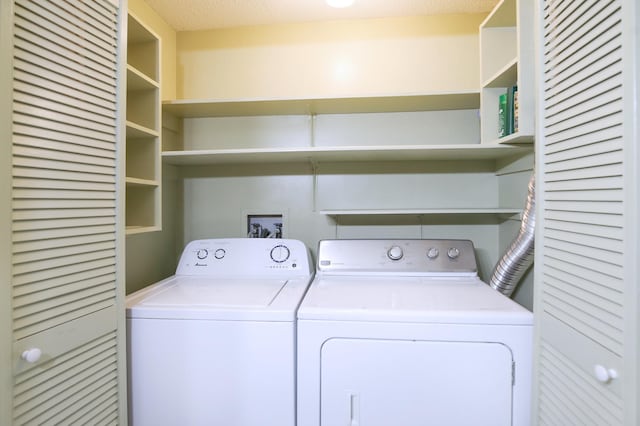 clothes washing area with separate washer and dryer