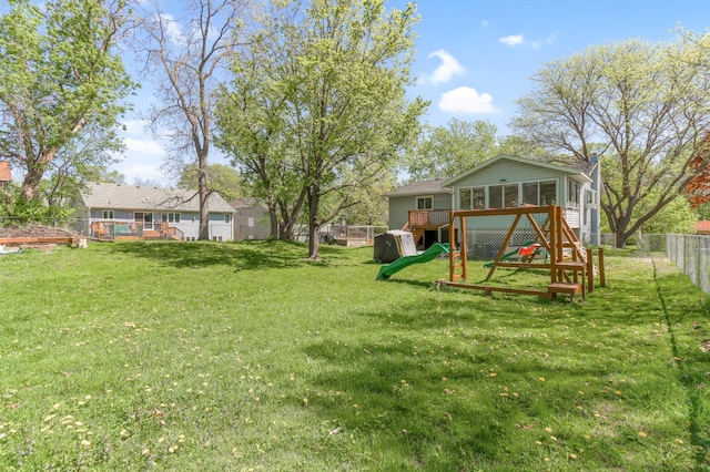 2515 Belmont Ln E, North Saint Paul, MN 55109 - view of yard with a sunroom and a wooden deck