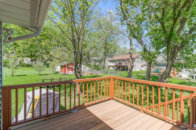 2515 Belmont Ln E, North Saint Paul, MN 55109 - wooden terrace featuring a storage shed, a residential view, and an outbuilding