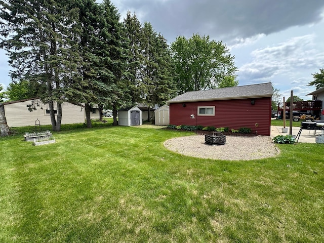 404 5th Ave NE, Kasson, MN 55944 - view of green lawn with an outdoor fire pit and a patio
