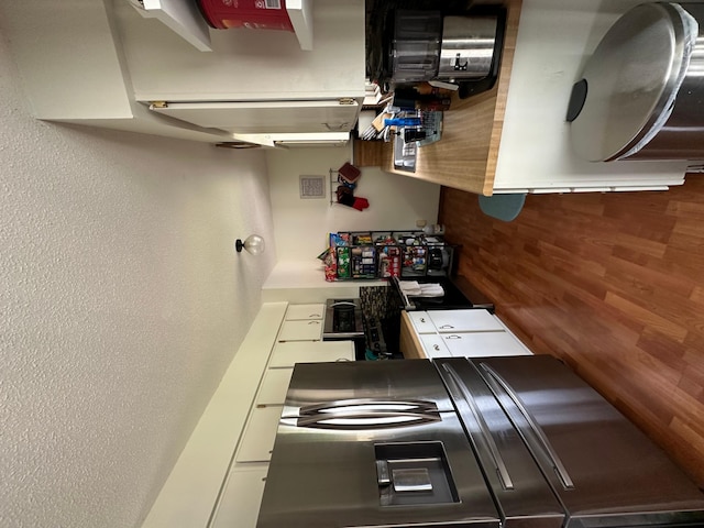 404 5th Ave NE, Kasson, MN 55944 - kitchen featuring stove, a textured wall, and white cabinets
