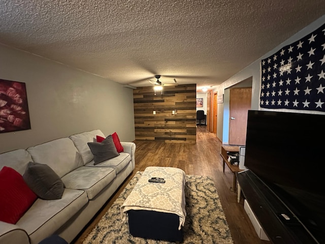 404 5th Ave NE, Kasson, MN 55944 - living room with a ceiling fan, wood finished floors, a textured ceiling, and wood walls