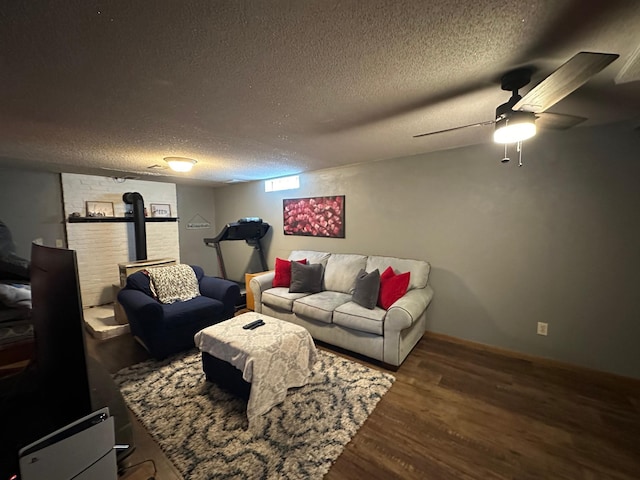 404 5th Ave NE, Kasson, MN 55944 - living room featuring a wood stove, wood finished floors, a textured ceiling, and a ceiling fan