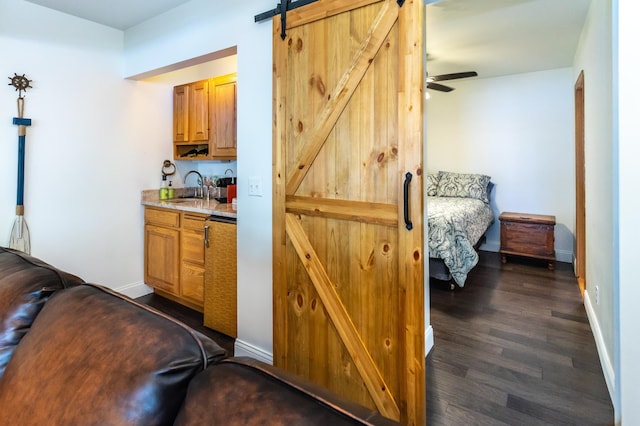 3010 Fairview Rd SW, Prior Lake, MN 55372 - indoor wet bar featuring dark wood-style floors, baseboards, and a barn door