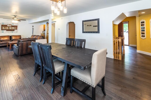 3010 Fairview Rd SW, Prior Lake, MN 55372 - dining room featuring arched walkways, a ceiling fan, dark wood-style flooring, and baseboards