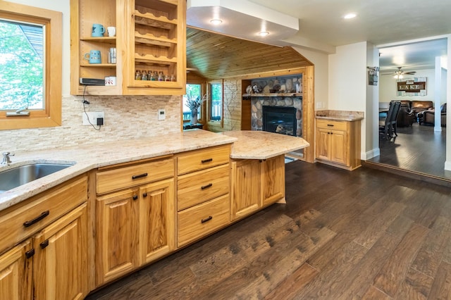 3010 Fairview Rd SW, Prior Lake, MN 55372 - kitchen with a stone fireplace, backsplash, light stone countertops, dark wood-style floors, and recessed lighting