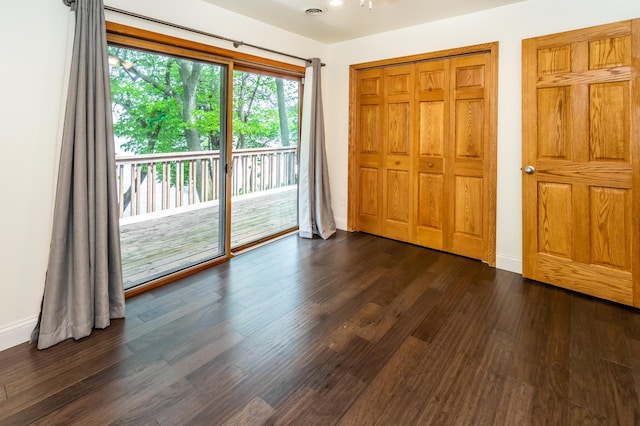 3010 Fairview Rd SW, Prior Lake, MN 55372 - unfurnished bedroom featuring access to outside, dark wood-style flooring, baseboards, and a closet