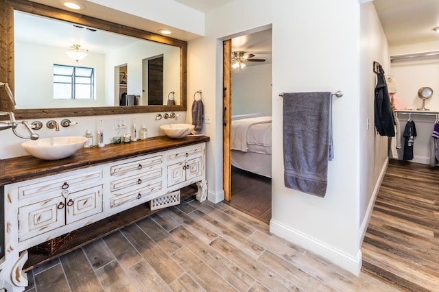 3010 Fairview Rd SW, Prior Lake, MN 55372 - ensuite bathroom with a ceiling fan, wood finished floors, baseboards, double vanity, and recessed lighting