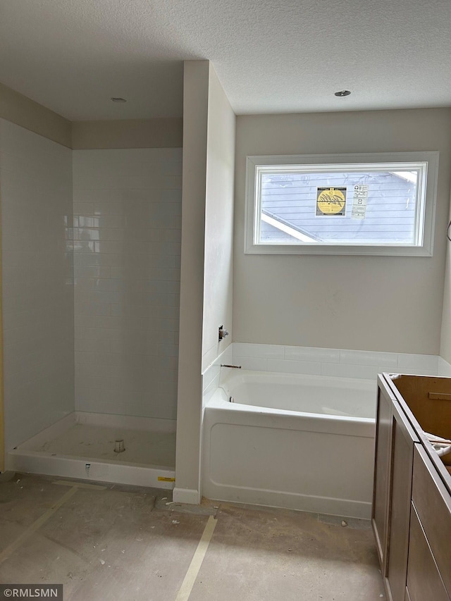 10101 Blackmoor Rd, Woodbury, MN 55129 - full bath with a garden tub, vanity, a textured ceiling, and a shower