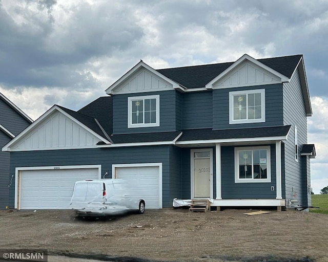 10101 Blackmoor Rd, Woodbury, MN 55129 - view of front of house with board and batten siding, roof with shingles, entry steps, and dirt driveway