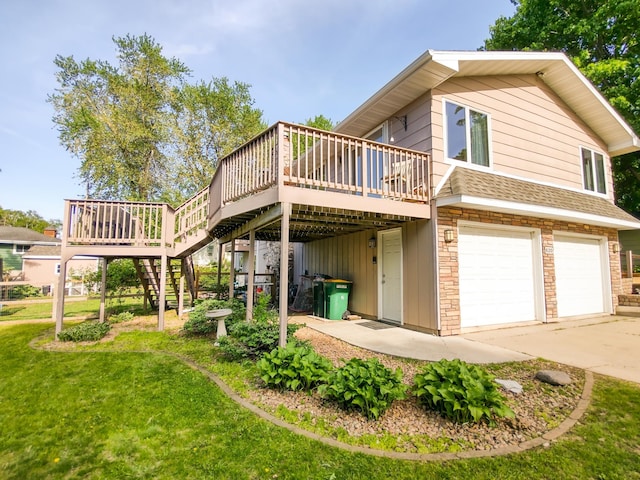 620 Maple St, Dassel, MN 55325 - back of property with a garage, a wooden deck, stairs, a lawn, and concrete driveway