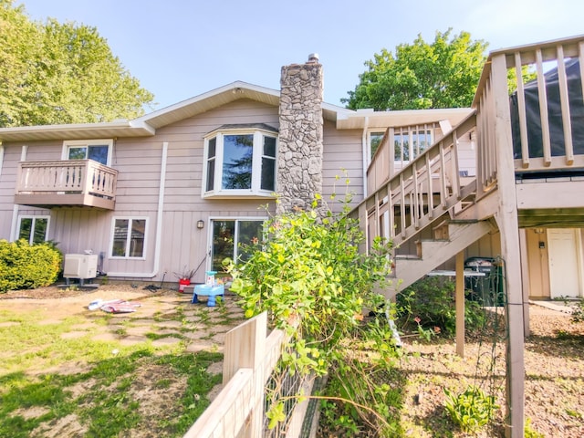 620 Maple St, Dassel, MN 55325 - back of house featuring a chimney, stairway, and a wooden deck