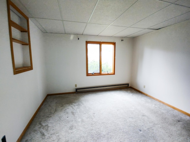620 Maple St, Dassel, MN 55325 - carpeted empty room featuring a baseboard heating unit, a drop ceiling, and baseboards