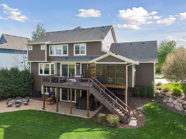 2971 Fairway Dr, Chaska, MN 55318 - back of house featuring a sunroom, a patio, a jacuzzi, stairway, and a yard