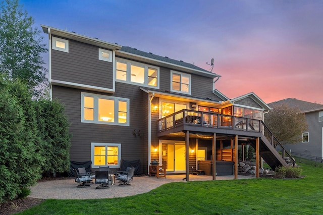 2971 Fairway Dr, Chaska, MN 55318 - back of property at dusk featuring a patio area, a hot tub, stairs, a wooden deck, and a sunroom