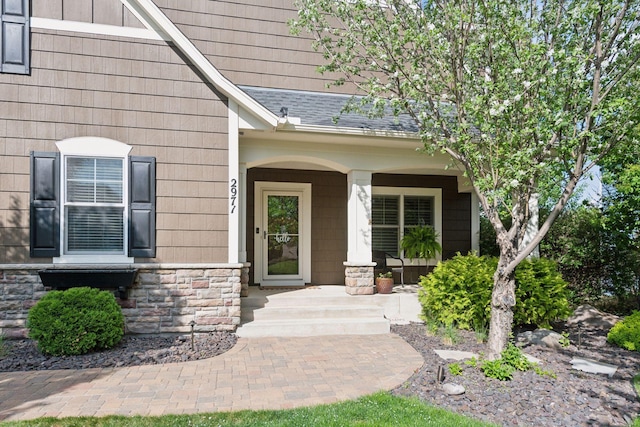 2971 Fairway Dr, Chaska, MN 55318 - property entrance featuring stone siding, a porch, and a shingled roof