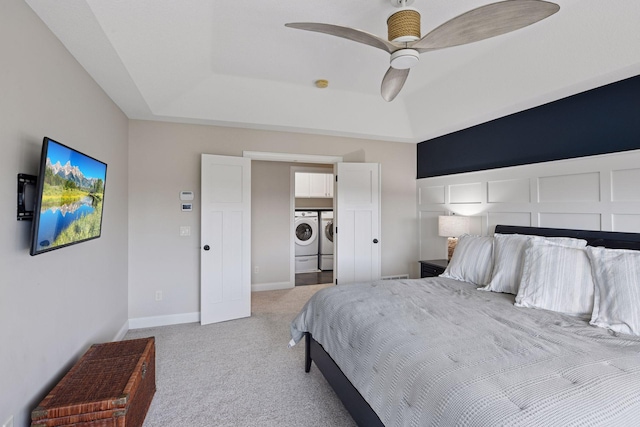 2971 Fairway Dr, Chaska, MN 55318 - bedroom with washer and clothes dryer, carpet flooring, a tray ceiling, and a ceiling fan