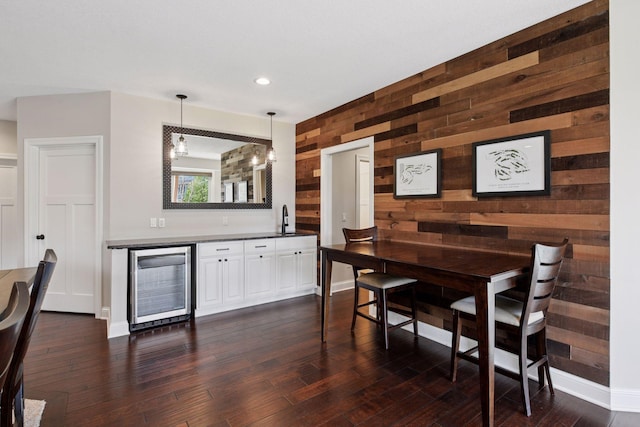 2971 Fairway Dr, Chaska, MN 55318 - dining space with beverage cooler, wood walls, baseboards, dark wood finished floors, and recessed lighting