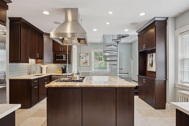 1785 Dupont Ave S, Minneapolis, MN 55403 - kitchen with island range hood, appliances with stainless steel finishes, a sink, a kitchen island, and dark brown cabinets