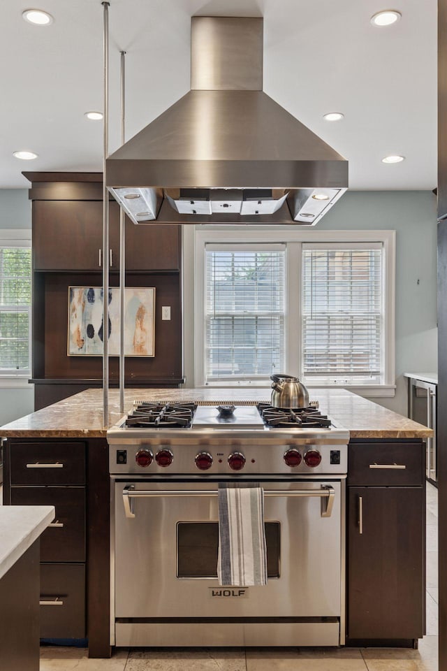 1785 Dupont Ave S, Minneapolis, MN 55403 - kitchen featuring premium range, wall chimney exhaust hood, dark brown cabinets, recessed lighting, and light stone counters