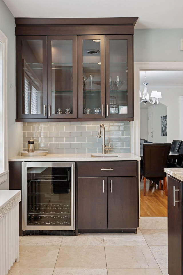 1785 Dupont Ave S, Minneapolis, MN 55403 - indoor wet bar with wine cooler, decorative backsplash, and a chandelier