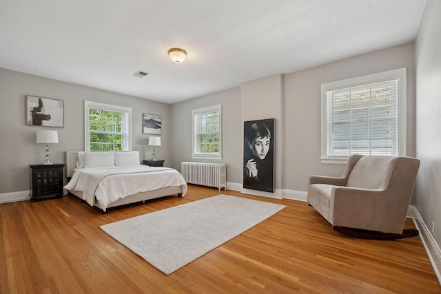 1785 Dupont Ave S, Minneapolis, MN 55403 - bedroom featuring radiator heating unit, light wood finished floors, and baseboards