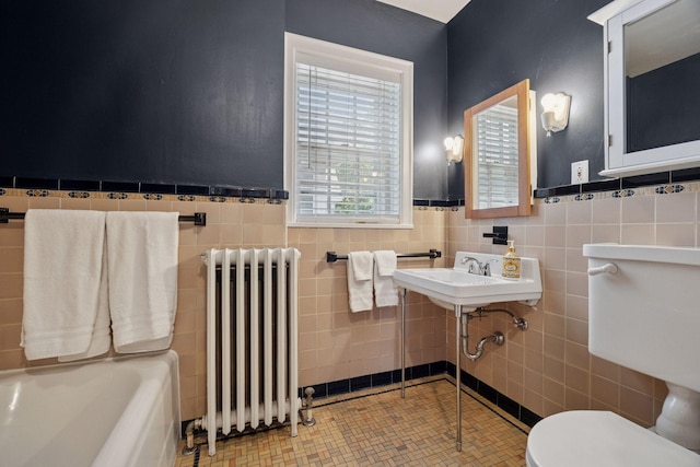 1785 Dupont Ave S, Minneapolis, MN 55403 - full bath with radiator, tile walls, toilet, a wainscoted wall, and a bathtub