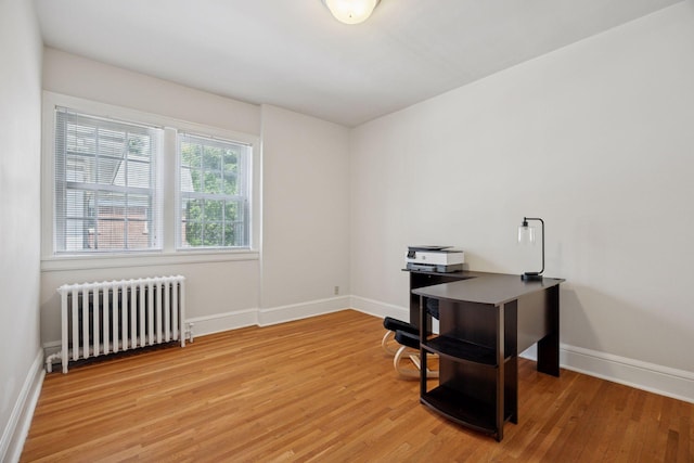 1785 Dupont Ave S, Minneapolis, MN 55403 - office area featuring radiator heating unit, light wood finished floors, and baseboards