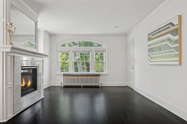 1785 Dupont Ave S, Minneapolis, MN 55403 - unfurnished living room with radiator, a tiled fireplace, wood finished floors, baseboards, and crown molding