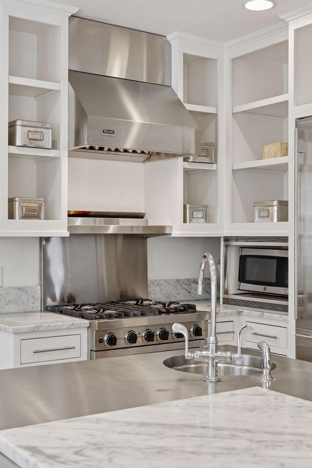 1785 Dupont Ave S, Minneapolis, MN 55403 - kitchen featuring wall chimney range hood, open shelves, stainless steel microwave, and white cabinets