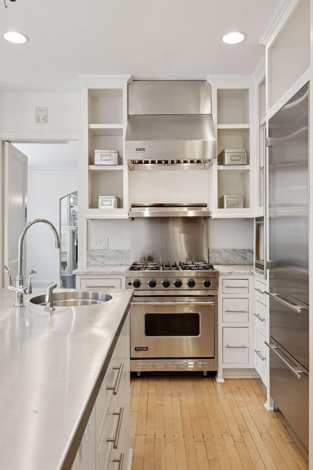 1785 Dupont Ave S, Minneapolis, MN 55403 - kitchen featuring stainless steel countertops, high end appliances, exhaust hood, open shelves, and recessed lighting