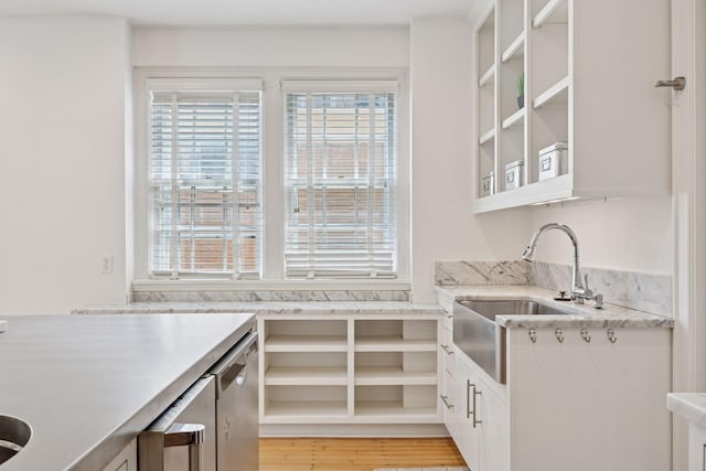 1785 Dupont Ave S, Minneapolis, MN 55403 - kitchen with white cabinetry, a sink, and light wood-style floors