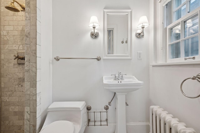 1785 Dupont Ave S, Minneapolis, MN 55403 - bathroom with radiator, tiled shower, and toilet