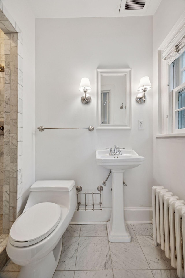1785 Dupont Ave S, Minneapolis, MN 55403 - bathroom with radiator heating unit, toilet, marble look tiles, a tile shower, and baseboards