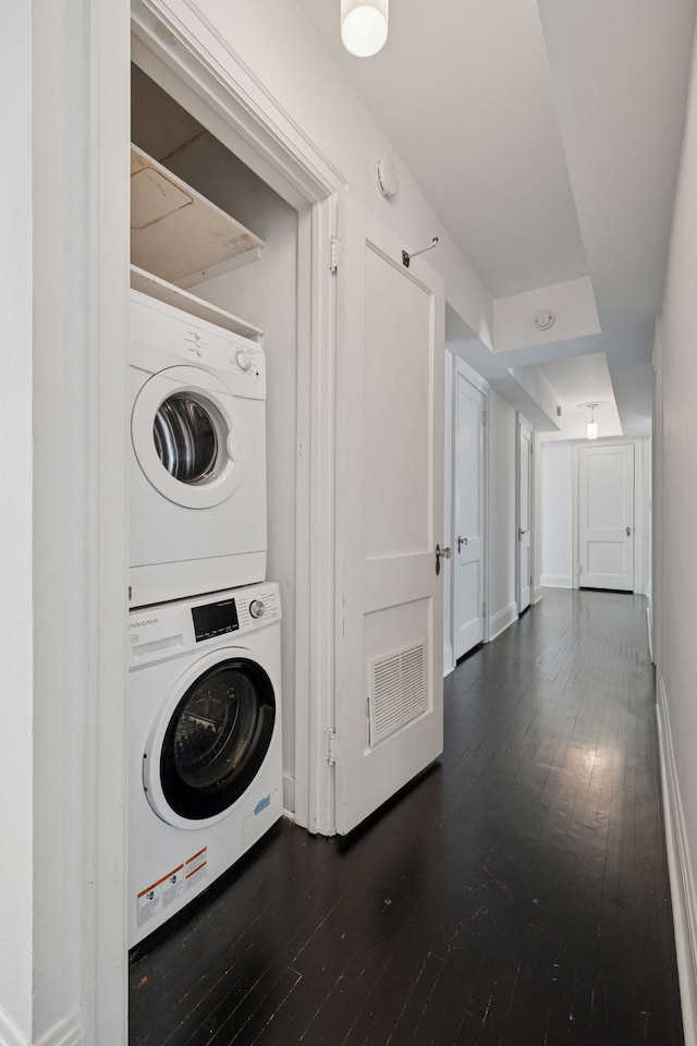 1785 Dupont Ave S, Minneapolis, MN 55403 - laundry area with stacked washer and clothes dryer, dark wood-style floors, and baseboards