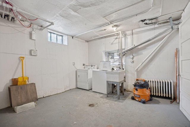 1785 Dupont Ave S, Minneapolis, MN 55403 - below grade area featuring washing machine and clothes dryer, radiator heating unit, and a sink