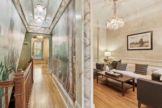 8 Grove St Unit 8B, Minneapolis, MN 55401 - hall with a chandelier, crown molding, wood finished floors, arched walkways, and a wainscoted wall