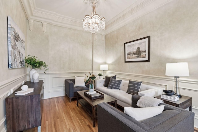 8 Grove St Unit 8B, Minneapolis, MN 55401 - living area featuring wood finished floors, ornamental molding, a decorative wall, a chandelier, and wainscoting