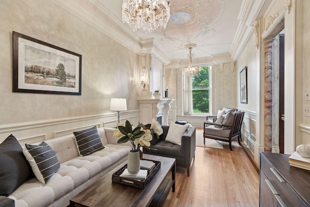 8 Grove St Unit 8B, Minneapolis, MN 55401 - living room with a chandelier, light wood-style flooring, crown molding, a decorative wall, and a wainscoted wall