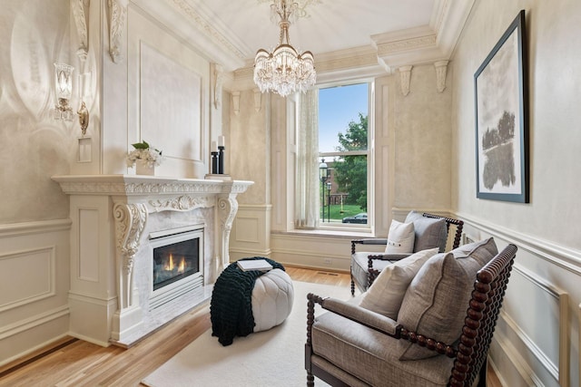 8 Grove St Unit 8B, Minneapolis, MN 55401 - living room with a decorative wall, crown molding, light wood-style flooring, a chandelier, and plenty of natural light