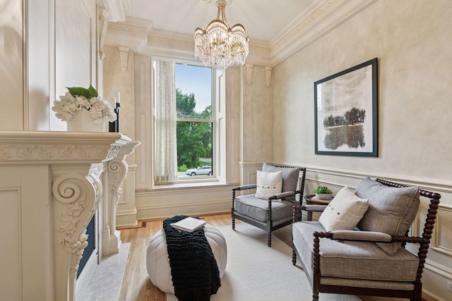 8 Grove St Unit 8B, Minneapolis, MN 55401 - sitting room featuring crown molding, a chandelier, healthy amount of natural light, light wood finished floors, and a decorative wall