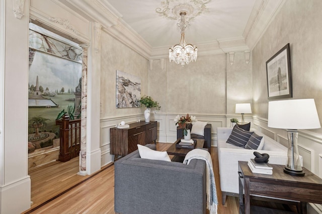 8 Grove St Unit 8B, Minneapolis, MN 55401 - living room featuring a decorative wall, light wood-style flooring, a chandelier, crown molding, and wainscoting