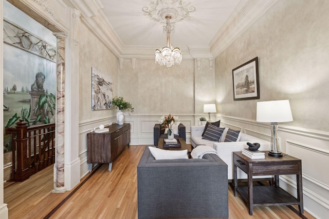 8 Grove St Unit 8B, Minneapolis, MN 55401 - living room with a decorative wall, a chandelier, light wood-type flooring, ornamental molding, and a wainscoted wall