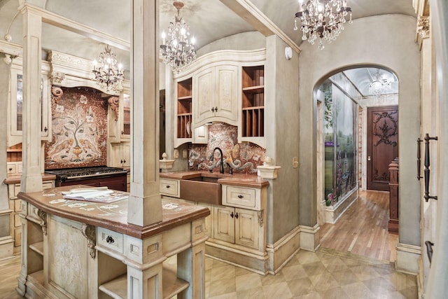 8 Grove St Unit 8B, Minneapolis, MN 55401 - kitchen featuring open shelves, arched walkways, cream cabinets, and a chandelier