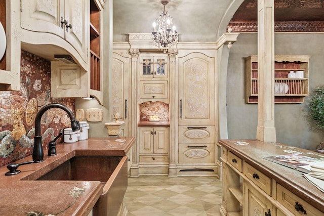 8 Grove St Unit 8B, Minneapolis, MN 55401 - kitchen featuring cream cabinets, light floors, a chandelier, and a sink