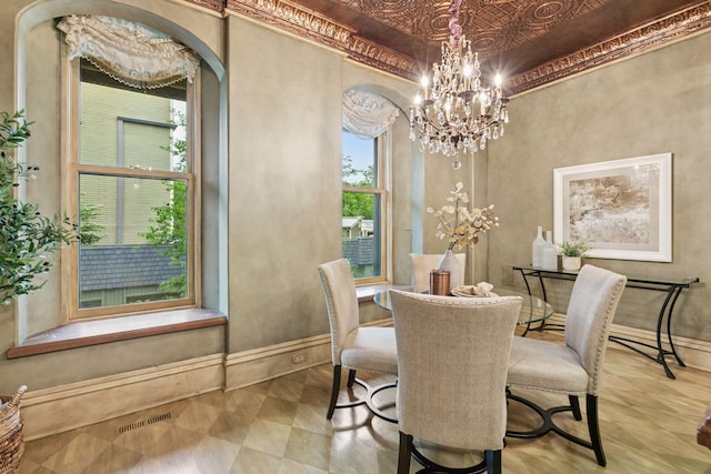 8 Grove St Unit 8B, Minneapolis, MN 55401 - dining room with a chandelier, baseboards, an ornate ceiling, and arched walkways