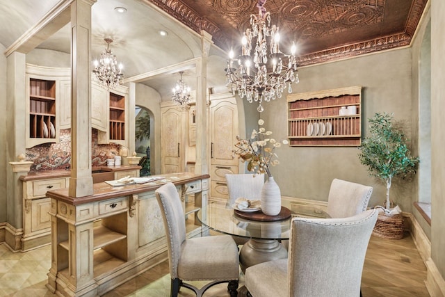 8 Grove St Unit 8B, Minneapolis, MN 55401 - dining area with a chandelier, crown molding, baseboards, and arched walkways
